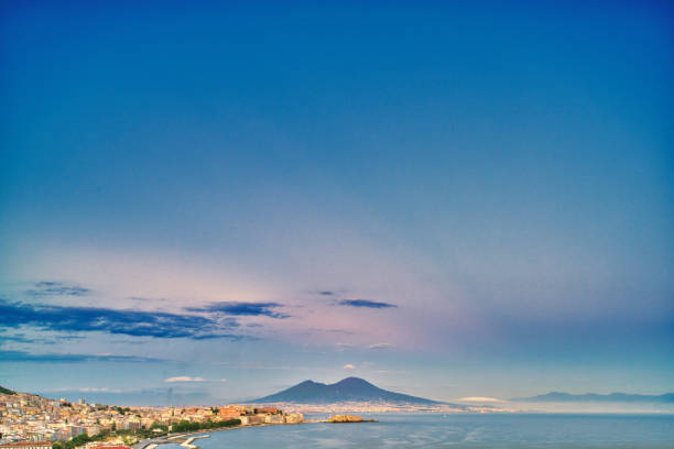 Looking over the Bay of Naples towards Mount Vesuvius in the background. Naples, Italian Napoli is the regional capital of Campania and the third-largest city of Italy, after Rome and Milan, with a population of almost 1million. It's the second-most populous metropolitan area in Italy and the 7th-most populous urban area in the European Union.