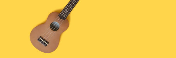 istock Creative banner with ukulele on a bright yellow background. 1267476350