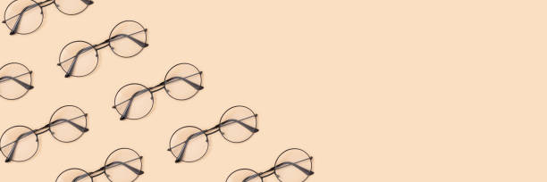 istock Frame made of round vintage eyeglasses pattern on a beige background. 1267476750