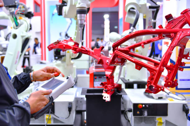 istock Engineer check and control automation Robot arm machine for Automotive structure of motorcycle 1267477631