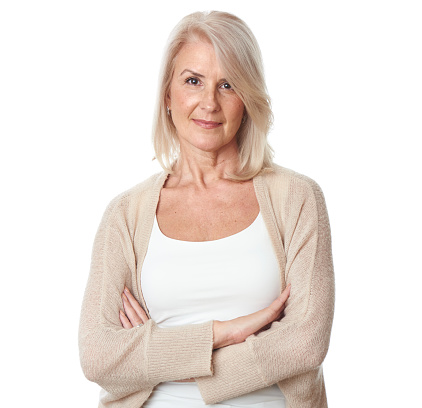 portrait of beautiful mature woman standing against white background.