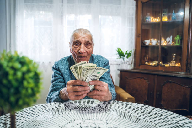 istock Senior man holding savings 1267479344