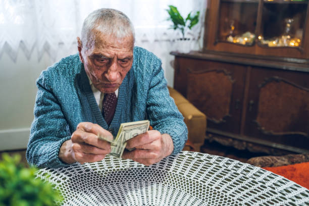 istock Senior man holding savings 1267479379