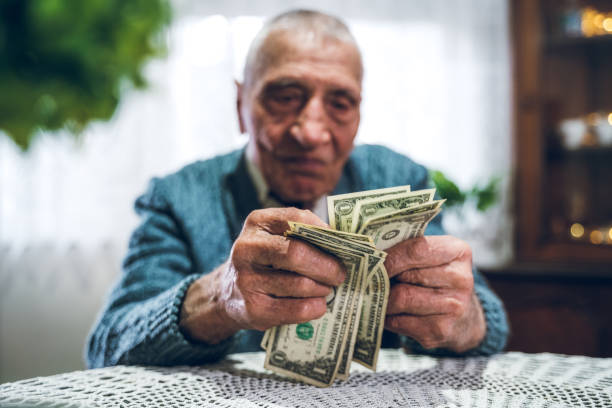 Senior man holding savings
