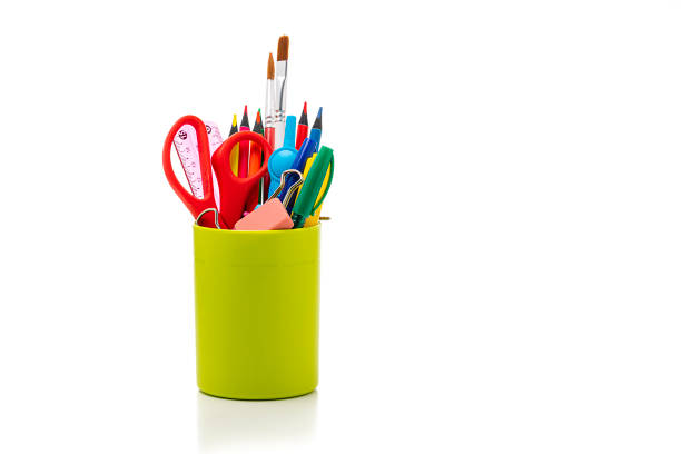 istock Desk organizer filled with some office or school supplies on white backdrop 1267479524