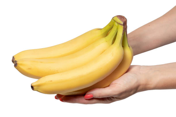 istock a banana in his hand on a white background 1267480834