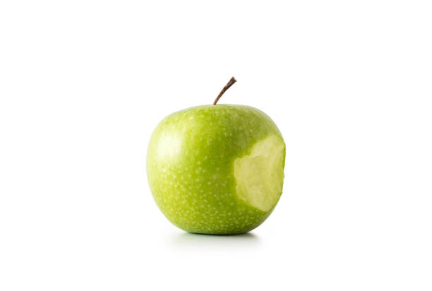 A bite on a green apple, isolated on white background.