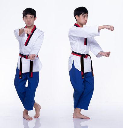 Master Black Belt TaeKwonDo Karate national athlete young teenager show traditional Fighting poses basic poomse in sport dress, studio lighting white background isolated, motion blur on foots hands