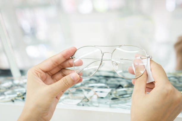 istock closeup hands choosing eyeglasses at optician store 1267483633