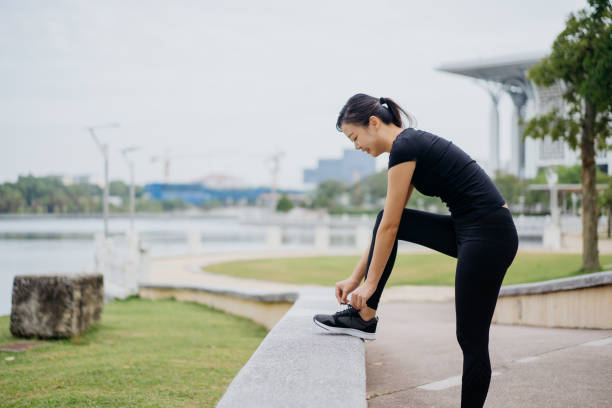 istock Young asian woman tying shoelace and ready for a run 1267483902