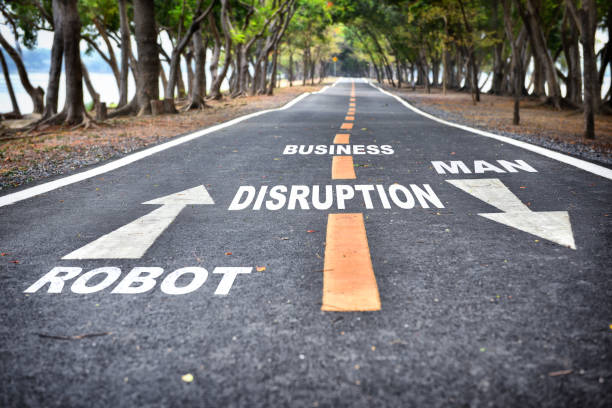 istock Robot vs man with arrow sign on road 1267485330