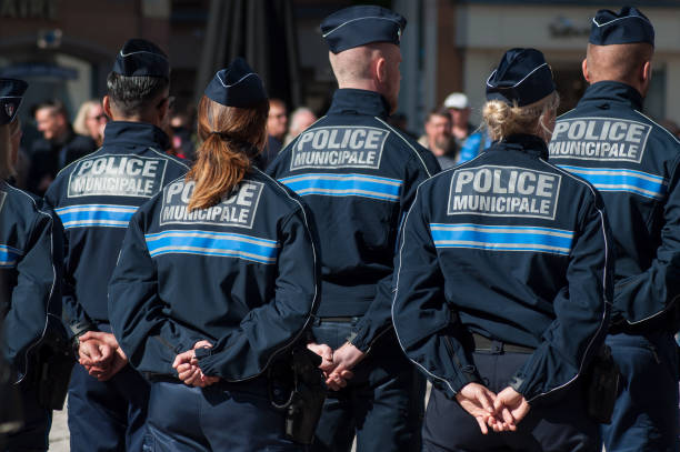 policemen standing on the main place during  the Thirtieth anniversary ceremony of the creation of the municipal police Mulhouse - France - 20 September 2019 -  Portrait of policemen standing on the main place during  the Thirtieth anniversary ceremony of the creation of the municipal police mulhouse photos stock pictures, royalty-free photos & images