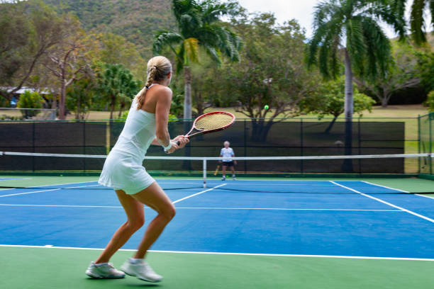 istock couple playing tennis in tropical climate 1267485593