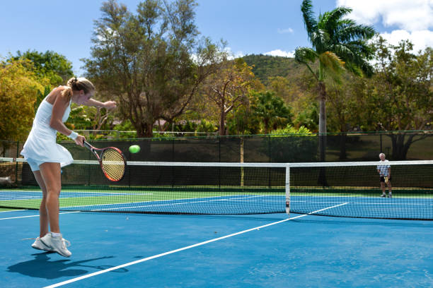 istock couple playing tennis in tropical climate 1267485595