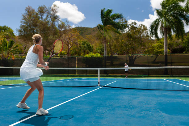 istock couple playing tennis in tropical climate 1267485596