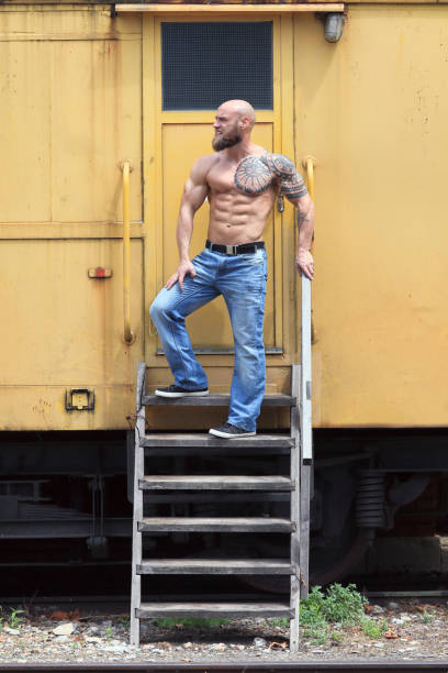 Powerful guy Powerful shirtless male posing on the rail station chest tattoos for men designs stock pictures, royalty-free photos & images