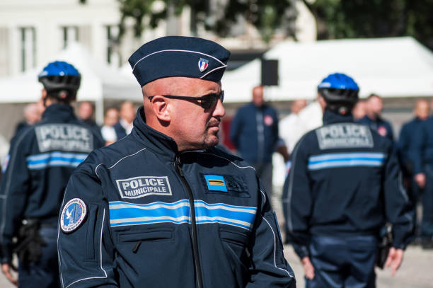 Portrait of municipal policeman looking on the main place during  the Thirtieth anniversary ceremony of the creation of the municipal police Mulhouse - France - 20 September 2019 -  Portrait of municipal policeman looking on the main place during  the Thirtieth anniversary ceremony of the creation of the municipal police mulhouse photos stock pictures, royalty-free photos & images