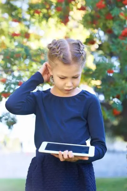 The girl in blue. Nature. The tablet