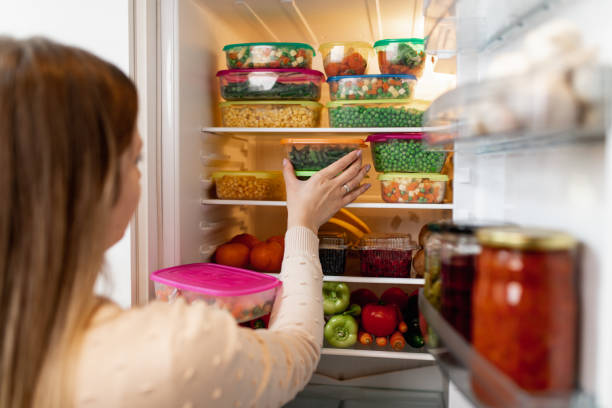 istock Woman taking raw food from refrigerator 1267490898