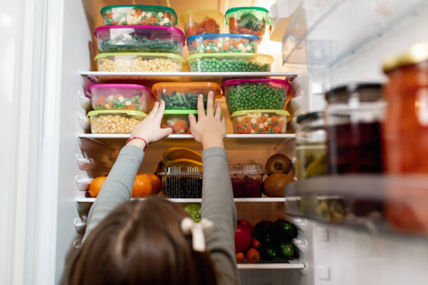 istock Girl taking raw food from refrigerator 1267490918
