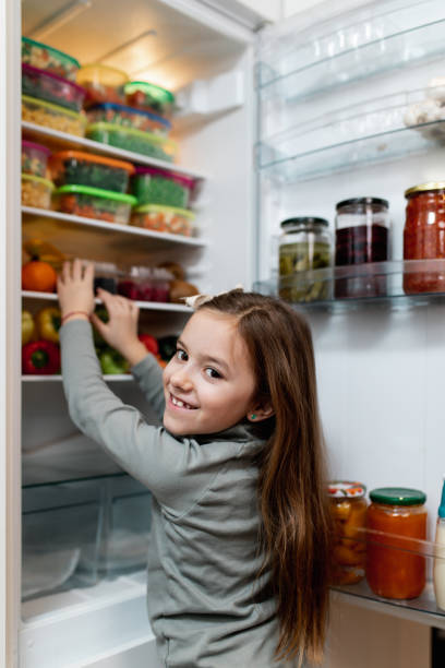 istock Girl taking raw food from refrigerator 1267490930
