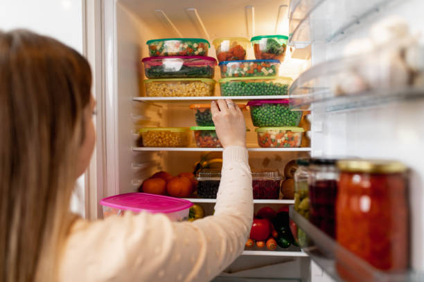 istock Woman taking raw food from refrigerator 1267490940