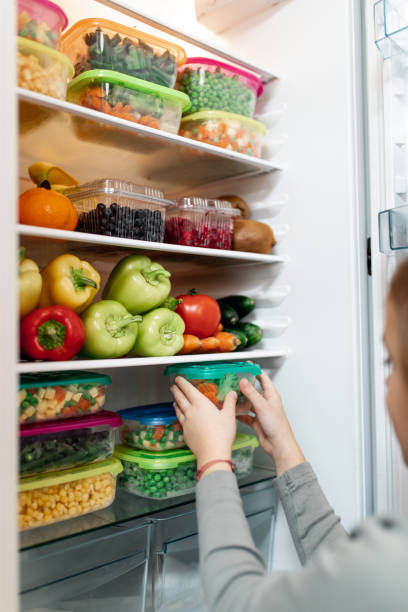 istock Girl taking raw food from refrigerator 1267490951