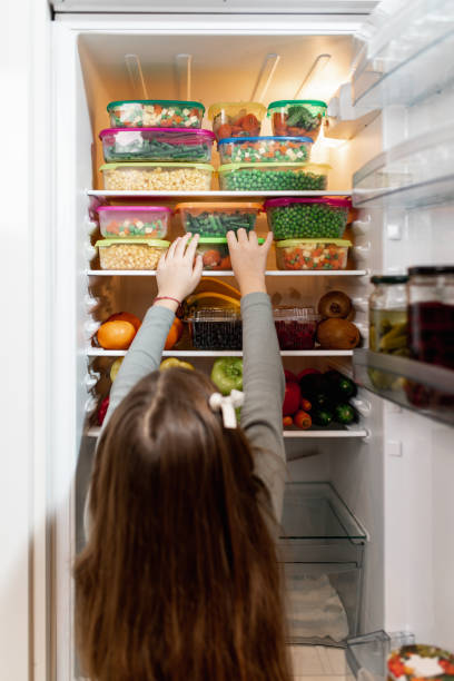 istock Girl taking raw food from refrigerator 1267490960