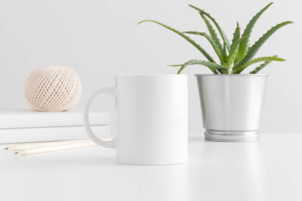 istock Mug mockup with workspace accessories and a succulent plant on a white table. 1267490977