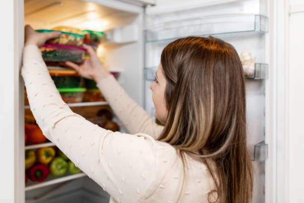 istock Woman taking raw food from refrigerator 1267490984