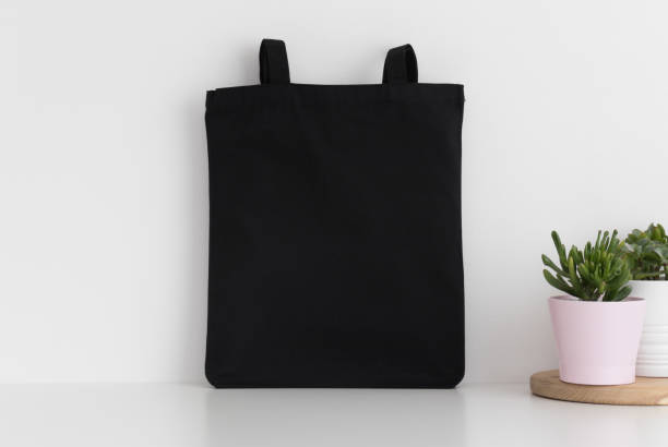 istock Black tote bag mockup with succulents on a white table. 1267491100