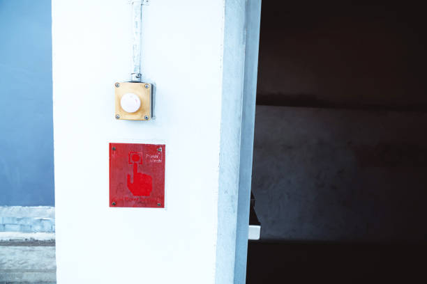istock The old alarm button outside and beside the fire exit door before going inside the building, the fire alarm button is very old, should be improved and ready to use at all times. 1267493962