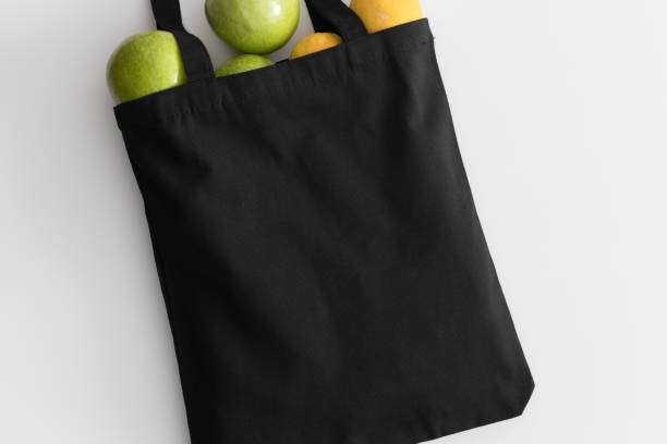 istock Black tote bag mockup with fruit on a white table. 1267494175