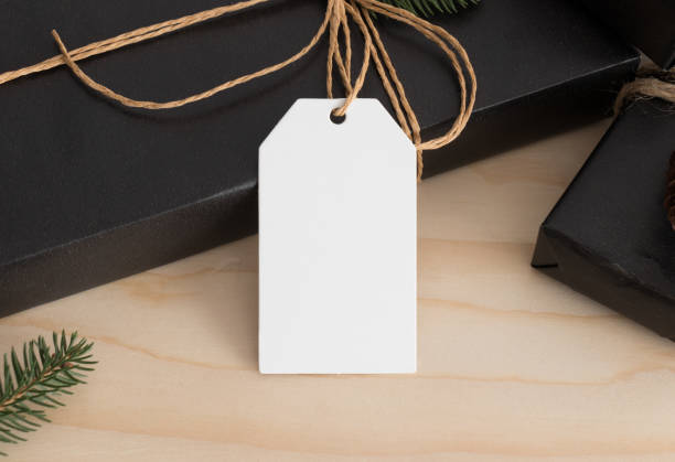 istock White blank tag mockup isolated on a black christmas gift. 1267494315
