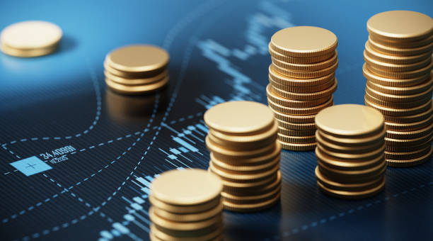 istock Coin Stacks Sitting on A Blue Financial Graph 1267497164