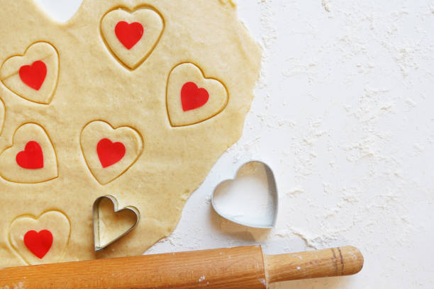istock Baking love heart cookies for Valentine day. Top view 1267497447