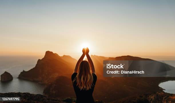 Young Woman In Spiritual Pose Holding The Light Stock Photo - Download Image Now - Nature, Wellbeing, Vitality