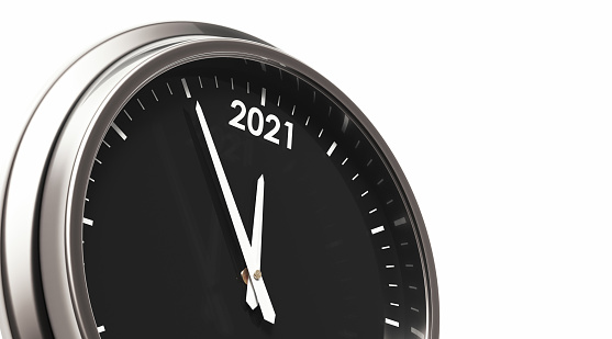 Silver framed wall clock over white background. The clock shows 2021. Horizontal composition with and copy space.