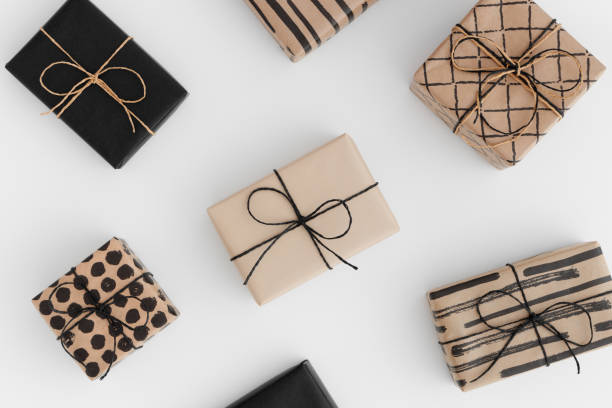 istock Black and kraft christmas gifts on a white table. 1267498905