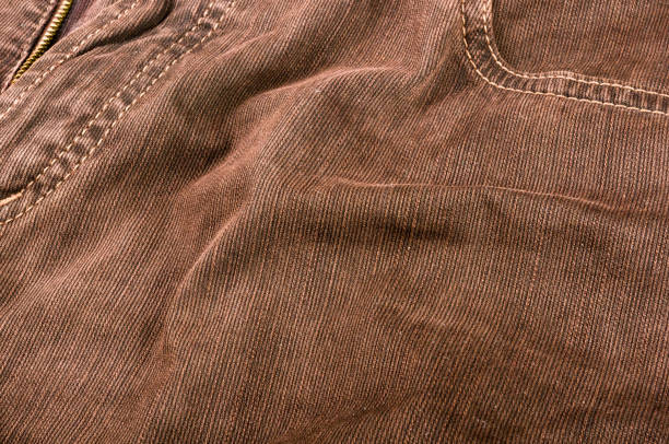 istock clothing items stonewashed cotton fabric texture with seams, clasps, buttons and rivets, macro 1267499077