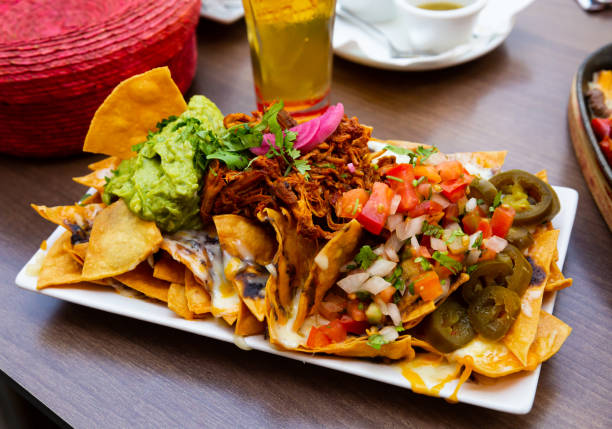 istock Nachos with meat, vegetables and Guacamole 1267499441