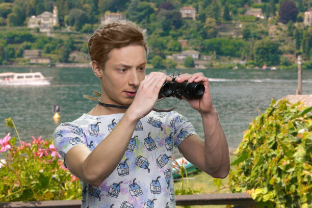 istock Teen boy observing sea with binoculars. 1267500719
