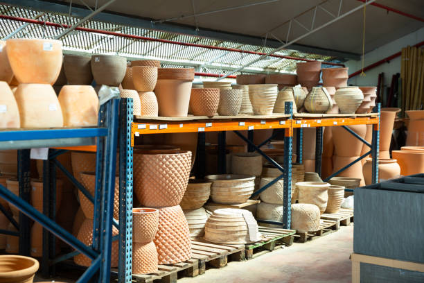 Rows with clay pots for plants in garden store