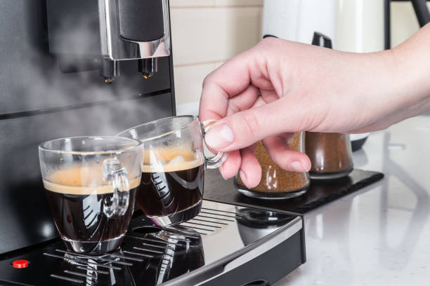 istock woman's hand picks up an espresso Cup 1267503632