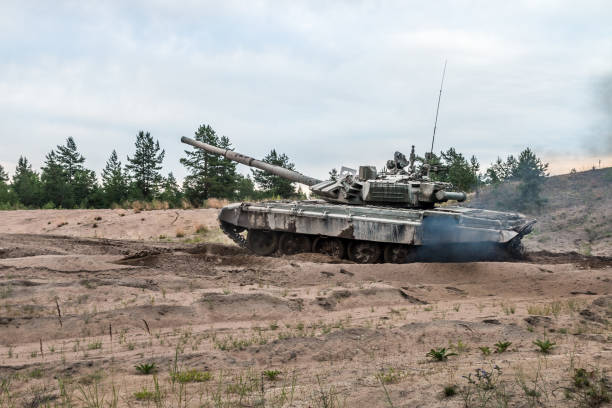 istock battle tank attacks the enemy on the road through 1267503688
