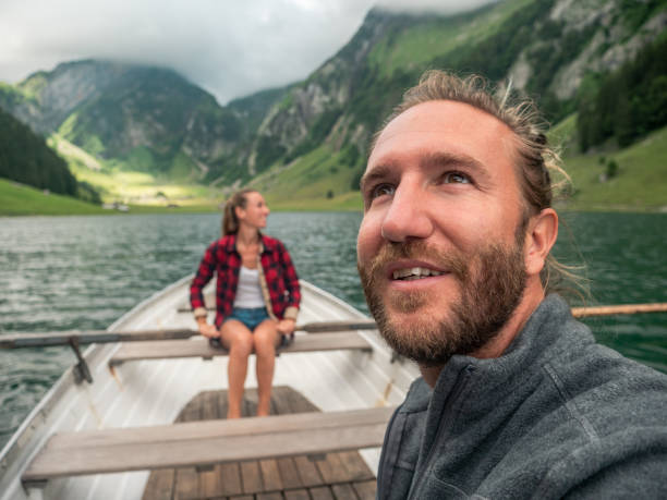 istock Couple relaxing on rowing boat, alpine lake 1267504901