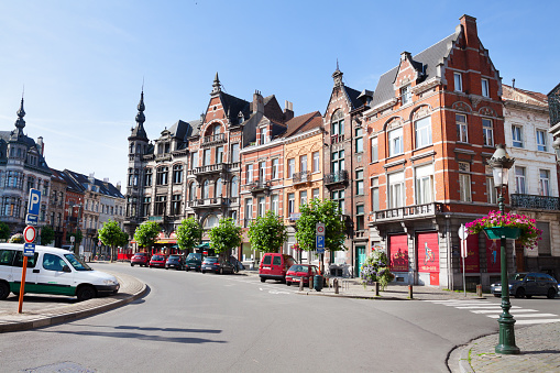 Street and roundabout Place Colignon in Brussels Schaerbeek. Capture is near local town hall. Old fin de siecle buildings are in this district. Cars are parked in street