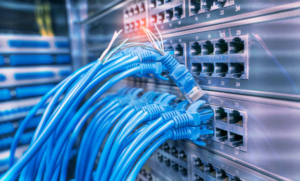 istock damaged stranded network cable is located on the background of the server room. Problem with communication 1267506409