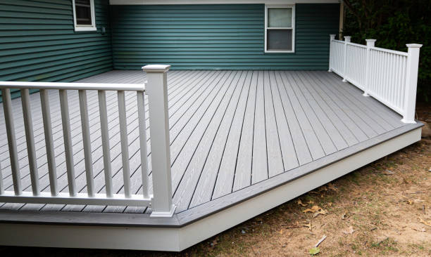 New composite deck New composite deck on the back of a house with green vinyl siding.with whie railings. railing photos stock pictures, royalty-free photos & images