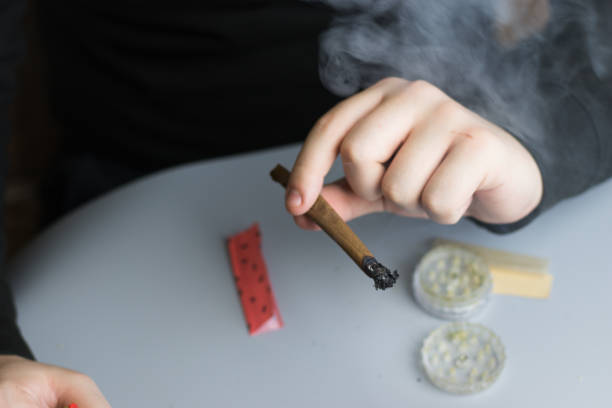 istock Man smoking cannabis blunt. Smoke clouds. Marijuana medical use 1267506744